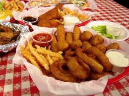 Fried food items, in the basket with side sauces